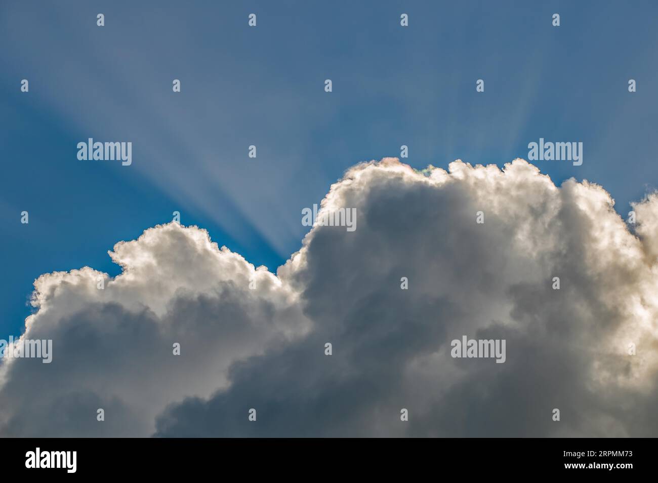 Rays of sunshine break through the clouds Stock Photo