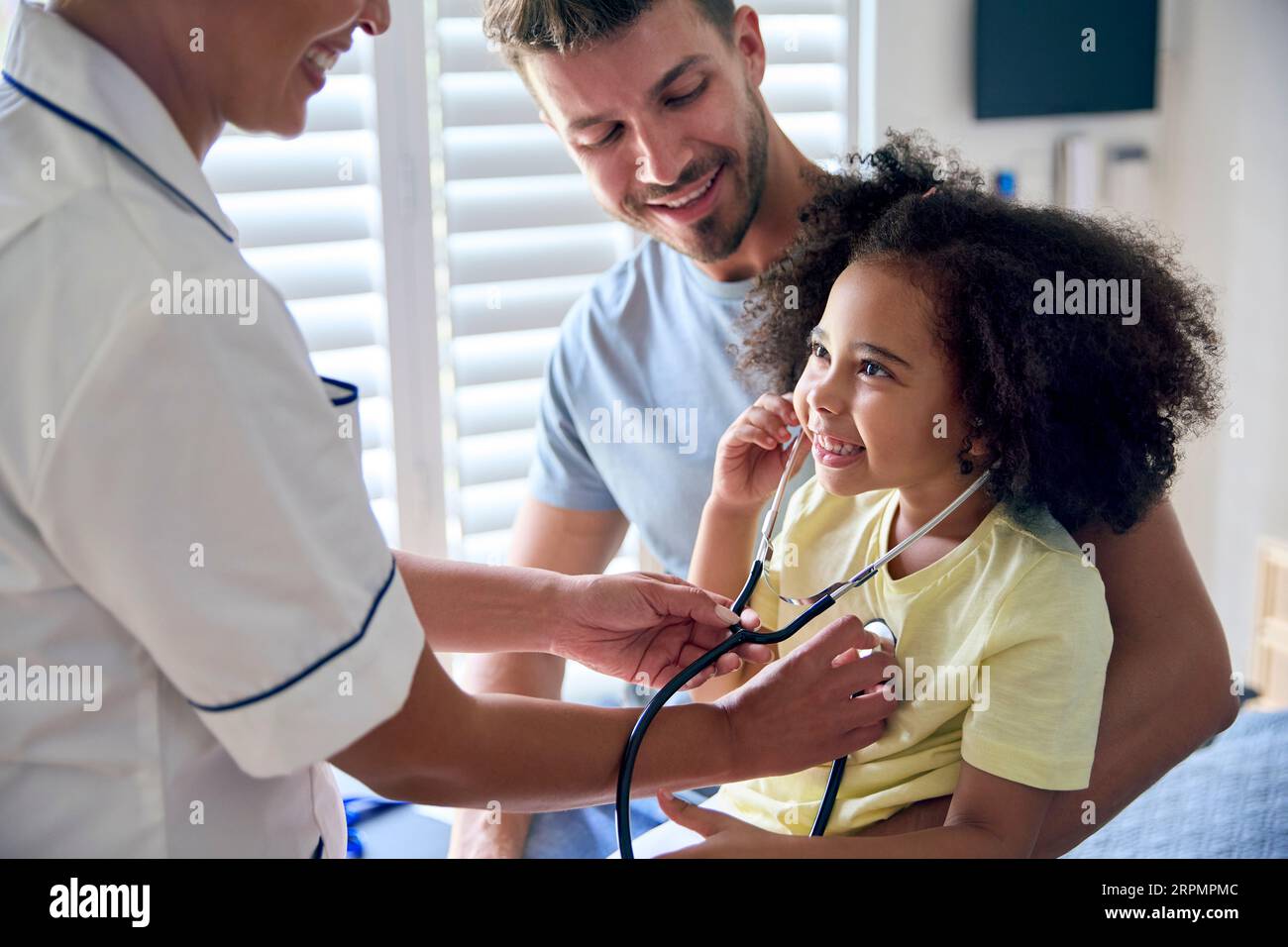 Nurse Wearing Uniform Gives Girl Stethoscope To Listen To Her Own Chest