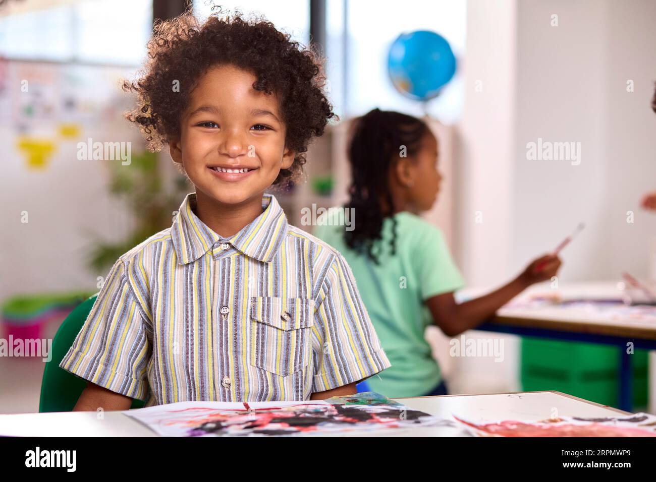 Classroom Portrait Of Smiling Male Elementary School Pupil In Art Class ...