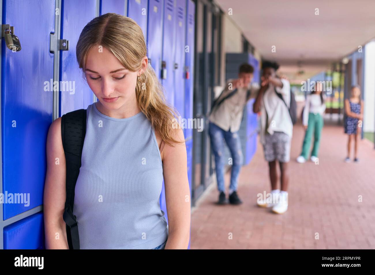Unhappy Teenage Girl Outdoors At High School Being Teased Or Bullied Stock Photo