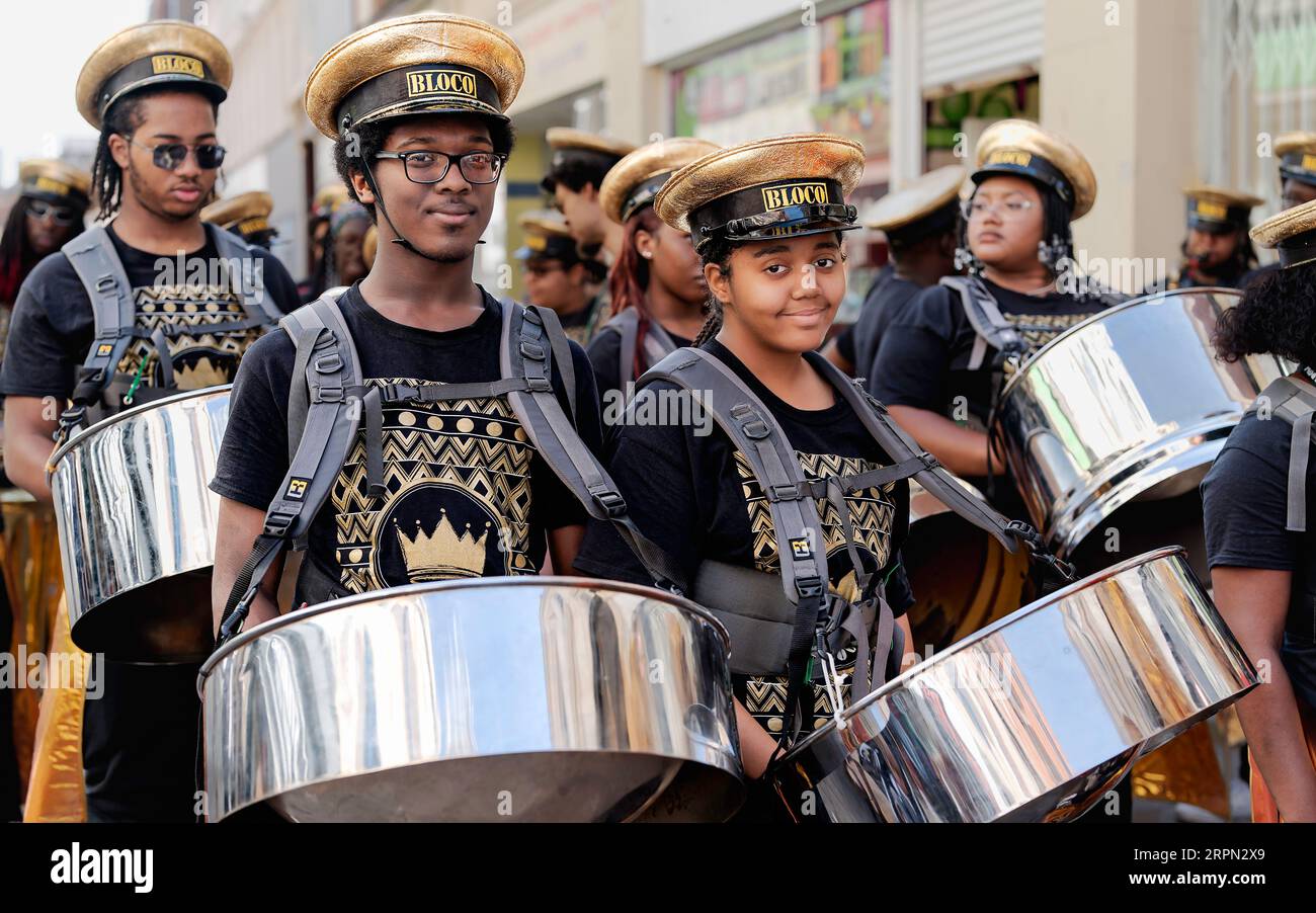 Steel pan orchestra playing along streets of central Hull entertaining