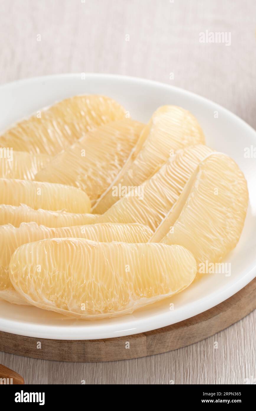 Close up of fresh peeled pomelo on wooden table background for Mid-Autumn Festival fruit. Stock Photo