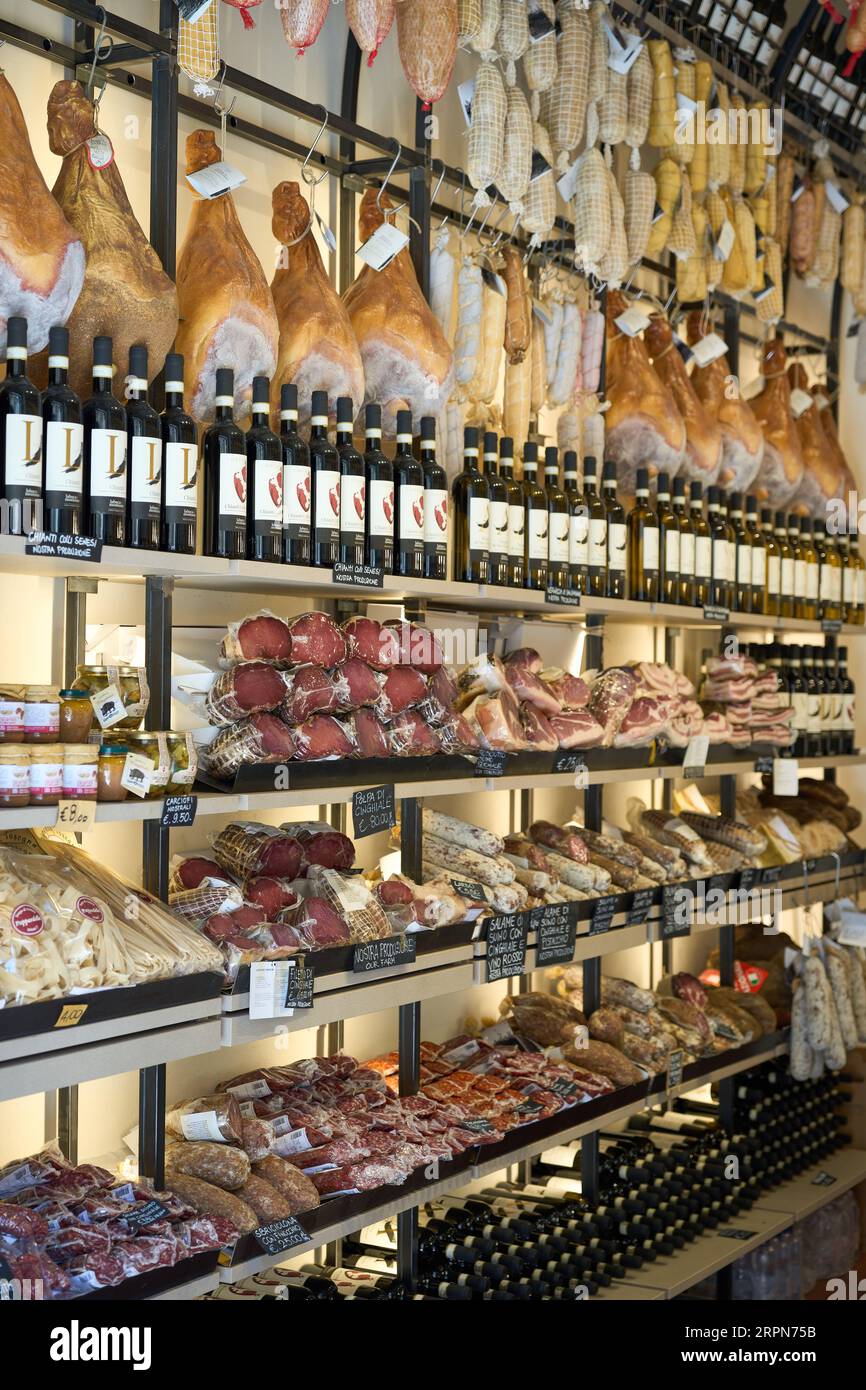 A display in a store an array of cured meats and other gourmet delicacies in Monteriggioni, Italy Stock Photo