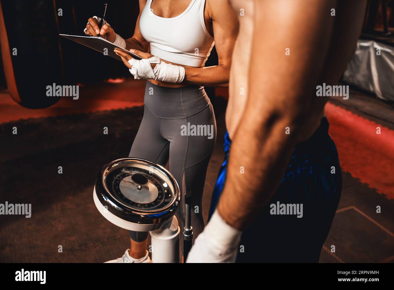 Boxer step on weight scale for boxing class designation by weight