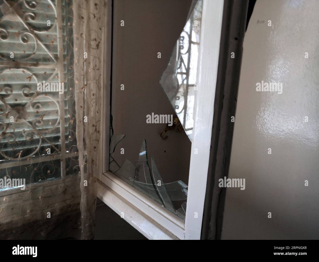 200228 -- TRIPOLI, Feb. 28, 2020 Xinhua -- A broken windows is seen in a resident s house in Abu Salim, southern Tripoli, Libya, Feb. 28, 2020. The forces of the UN-backed Libyan government said on Friday that the rival east-based army attacked the Mitiga International Airport in Tripoli with heavy shelling. Haftar commander of the east-based army targeted the Mitiga Airport and its surroundings, as well as a number of residential neighborhoods in the capital Tripoli, with more than 60 Grad missiles, the UN-backed government forces said in a statement. Photo by Hamza Turkia/Xinhua LIBYA-TRIPOL Stock Photo