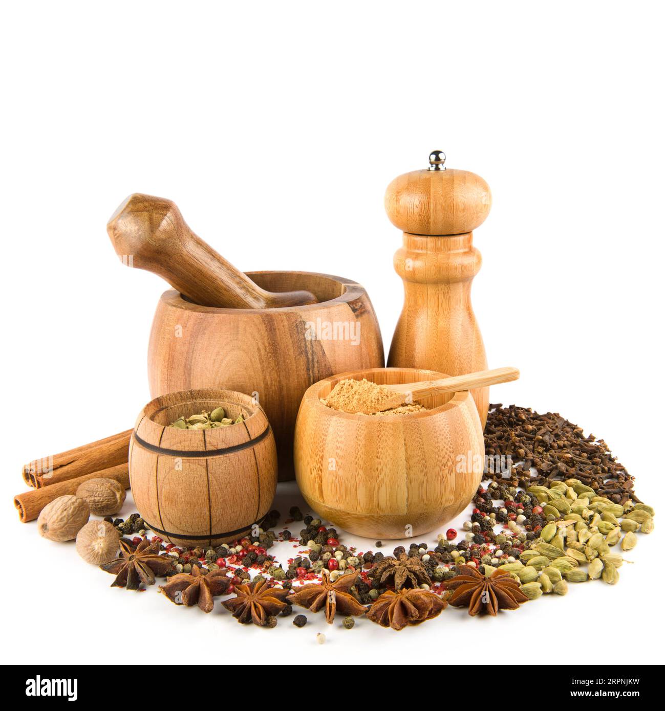 Wooden pestle, mortar, grinder and spices set isolated on white
