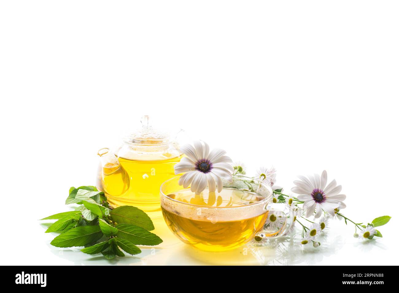 Chamomile flower tea in glass cup and teapot, isolated on white ...
