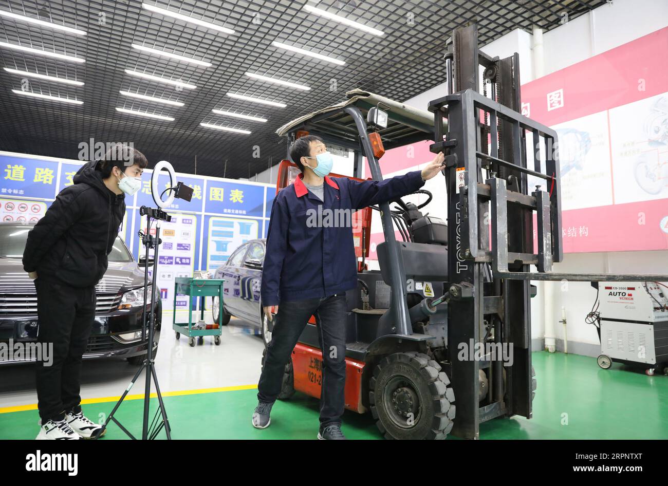 200305 -- ANSHAN, March 5, 2020 -- Teacher Yang Yongxiang R teaches forklift driving via internet at a vocational school in Anshan, northeast China s Liaoning Province, March 4, 2020. Vocational schools here have provided all kinds of classes via internet for over ten thousand students since March 2.  CHINA-LIAONING-VOCATIONAL EDUCATION-ONLINE TUITION CN YaoxJianfeng PUBLICATIONxNOTxINxCHN Stock Photo