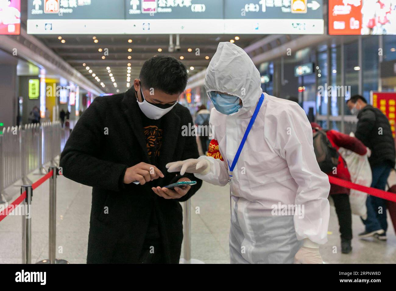 200305 -- SHANGHAI, March 5, 2020 -- Volunteer Shen Xiaoping R helps a passenger register for his health information at the Shanghai Hongqiao Railway Station in Shanghai, east China, March 5, 2020. Over 206,900 volunteers in Shanghai have joined the battle against the novel coronavirus outbreak, according to the Shanghai Association of Volunteers. Photo by /Xinhua CHINA-SHANGHAI-COVID-19-VOLUNTEERS CN WangxXiang PUBLICATIONxNOTxINxCHN Stock Photo