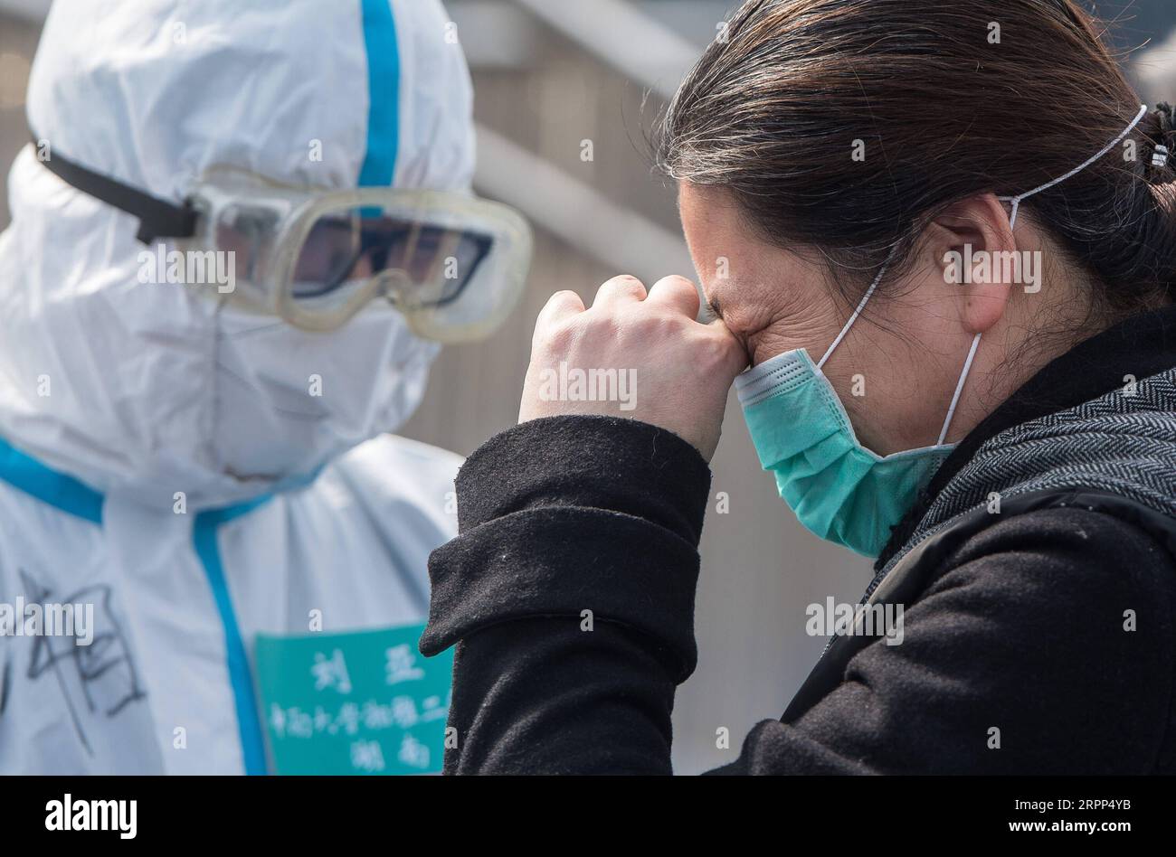 200311 -- BEIJING, March 11, 2020 -- A cured coronavirus patient weeps out of joy as leaving the Wuchang temporary hospital in Wuhan, central China s Hubei Province, March 10, 2020.  XINHUA PHOTOS OF THE DAY XiaoxYijiu PUBLICATIONxNOTxINxCHN Stock Photo