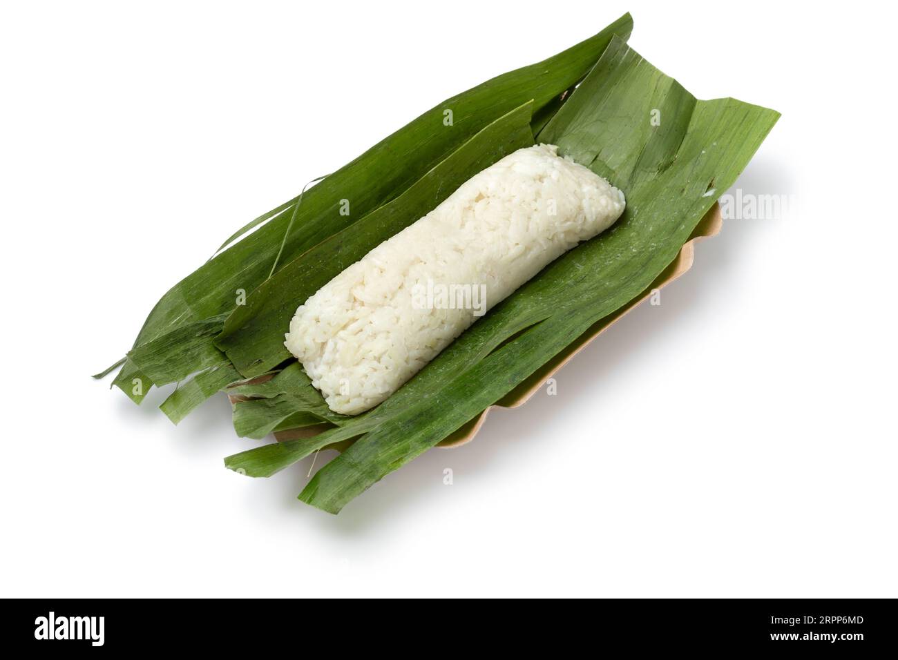 Whole Lemper Ayam wrapped in banana leaves, an Indonesian savoury snack made of glutinous rice filled with seasoned shredded chicken close up isolated Stock Photo