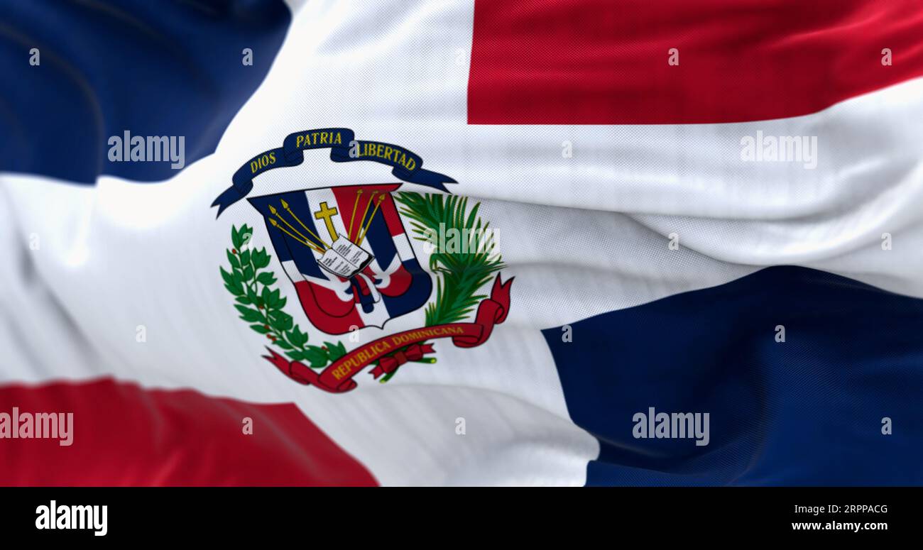 Close-up of the Dominican Republic flag waving. Red and blue flag with white cross, coat of arms in center. 3d illustration render. Rippled fabric. Te Stock Photo