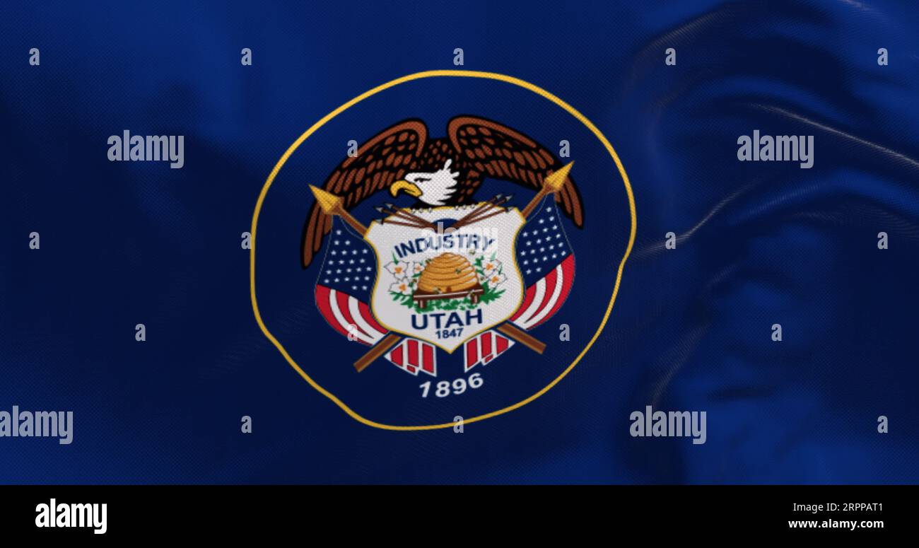 Closeup of Utah state flag waving. State seal encircled in a golden