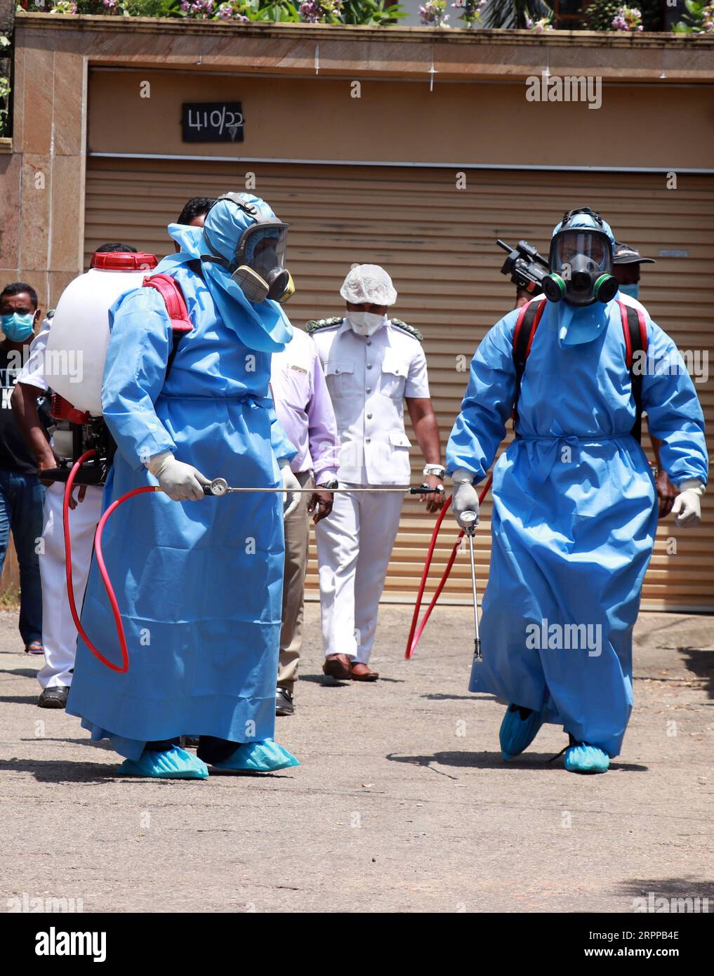 200314 -- COLOMBO, March 14, 2020 -- Health workers wearing protective suits spray disinfectant on a housing complex in Colombo, Sri Lanka, March 14, 2020. The number of confirmed cases of COVID-19 in Sri Lanka rose to 10 on Saturday evening with the latest being two females aged 56 and 17 years old, the Health Ministry said in a statement here. All the patients are currently receiving treatment at the Infectious Disease Hospital on the outskirts of the capital and the Polonnaruwa Hospital in north central Sri Lanka. Photo by /Xinhua SRI LANKA-COLOMBO-COVID-19 AjithxPerera PUBLICATIONxNOTxINxC Stock Photo