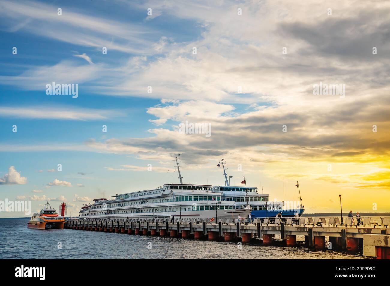 Cruise motor ships moored at the pier at sunset. Excursion tours on rivers and lakes of Russia. Stock Photo