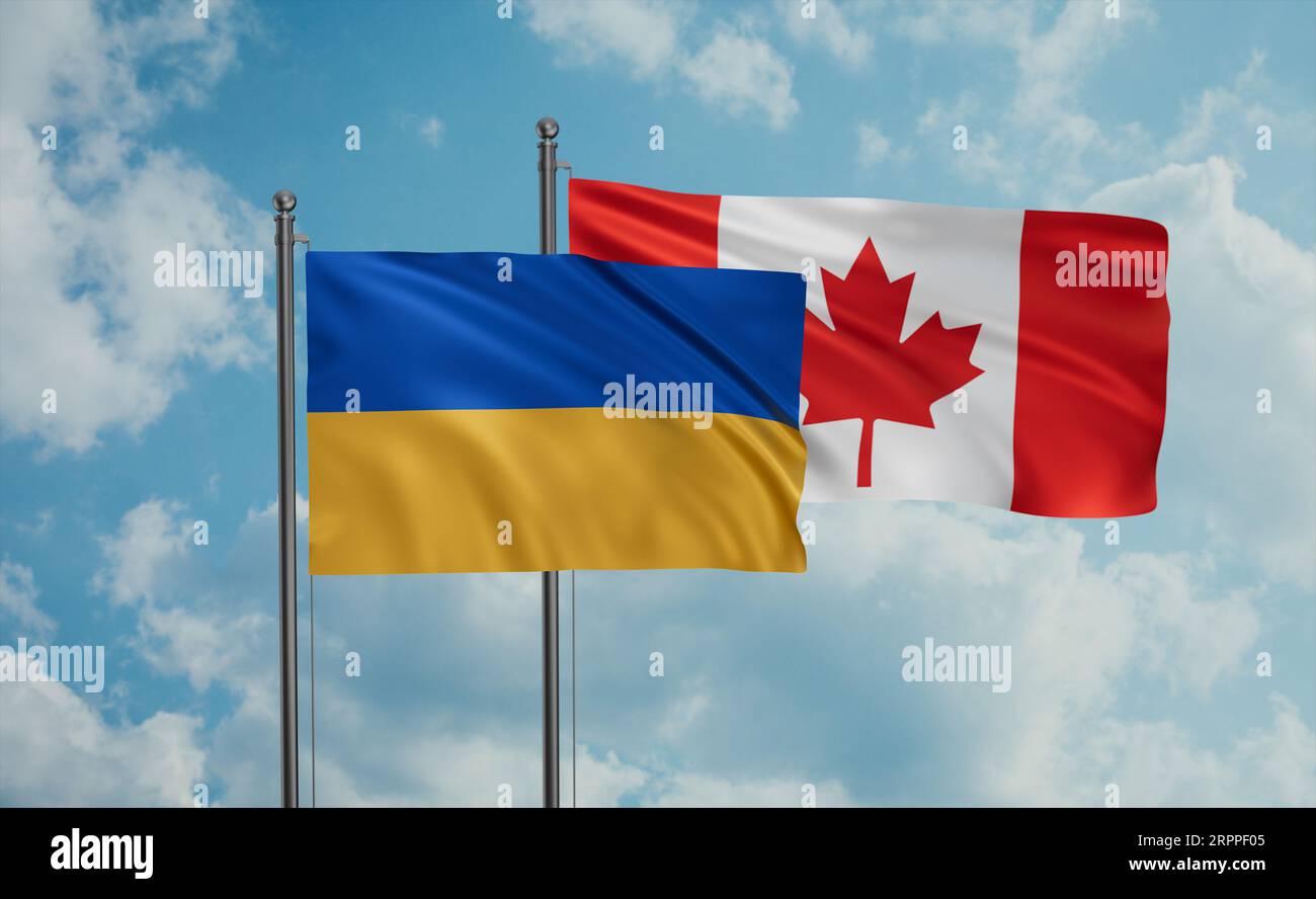 Canada and Ukraine flag waving together in the wind on blue sky, two ...