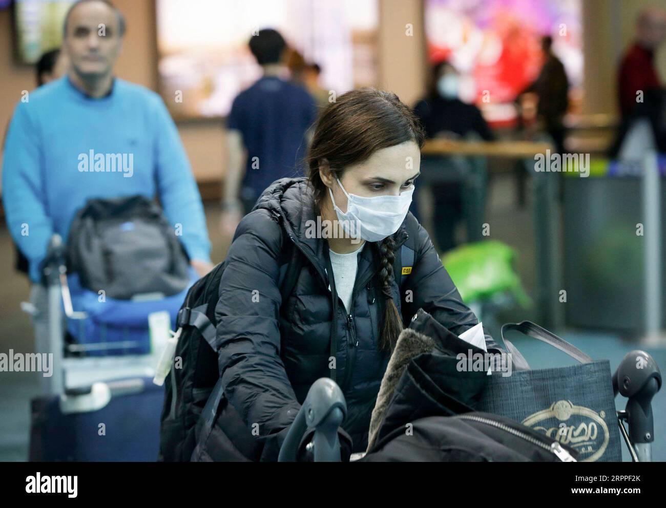 200316 -- VANCOUVER, March 16, 2020 Xinhua -- A traveller wearing face mask arrives at Vancouver International Airport in Richmond, Canada, March 16, 2020. Canadian Prime Minister Justin Trudeau announced a series of new measures on Monday afternoon to further contain the COVID-19 spread in Canada. Photo by Liang Sen/Xinhua CANADA-VANCOUVER-COVID-19 PUBLICATIONxNOTxINxCHN Stock Photo