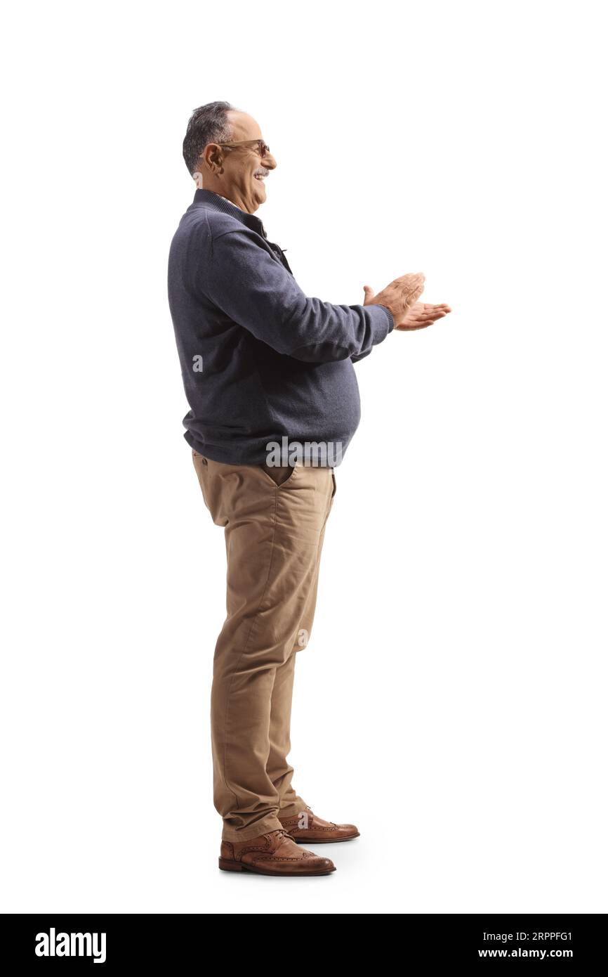 Full length profile shot of a happy mature man clapping with hands isolated on white background Stock Photo