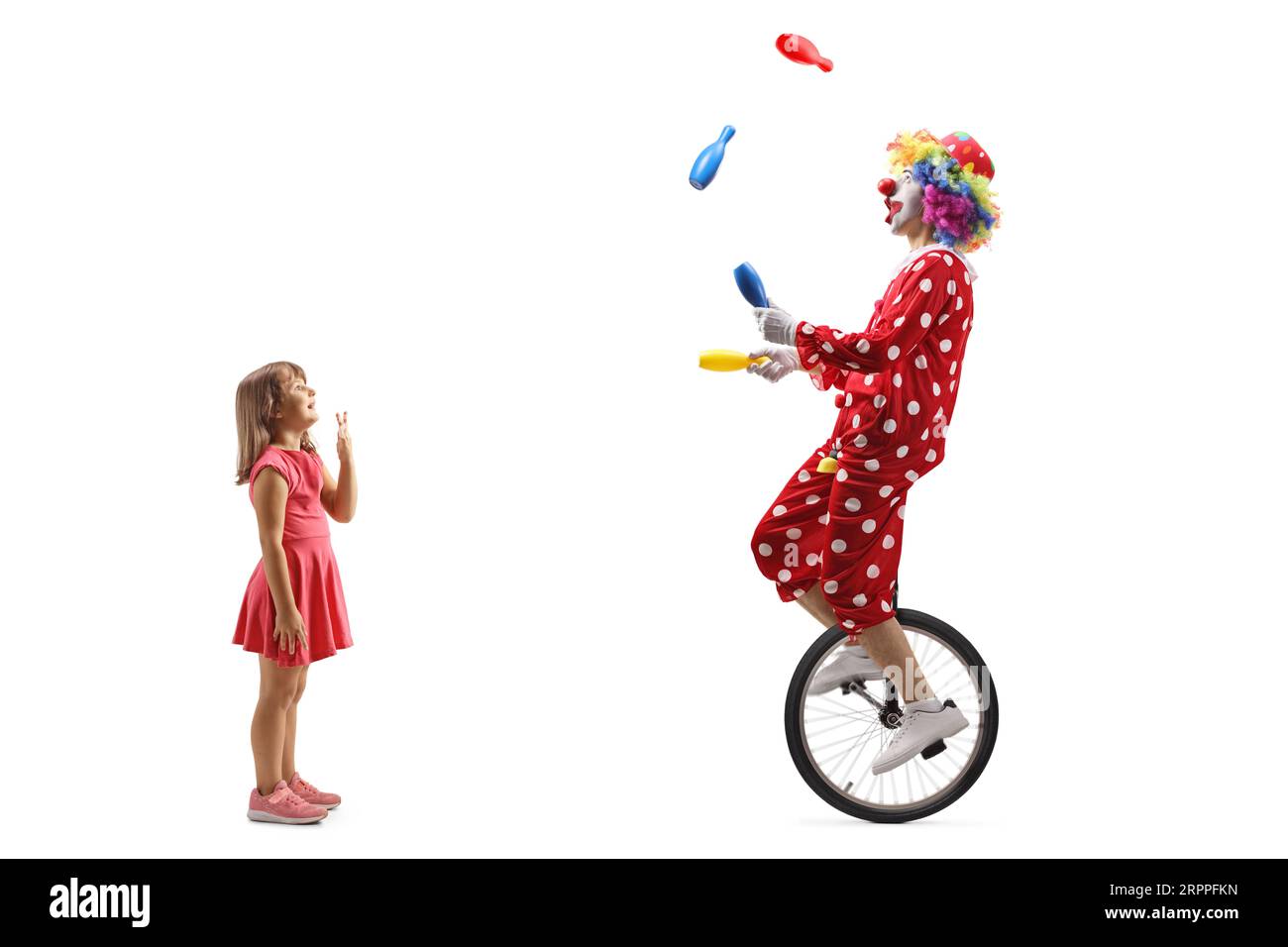 Full length profile shot of a surprised girl looking at a clown ...