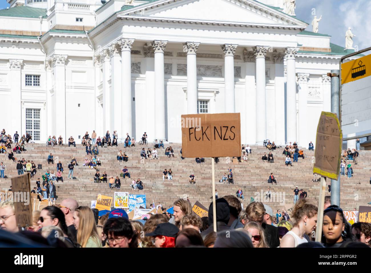 Protestors and signs in front of the Helsinki Cathedral during the ’End the silence!’ demonstration against racism and fascism. Stock Photo