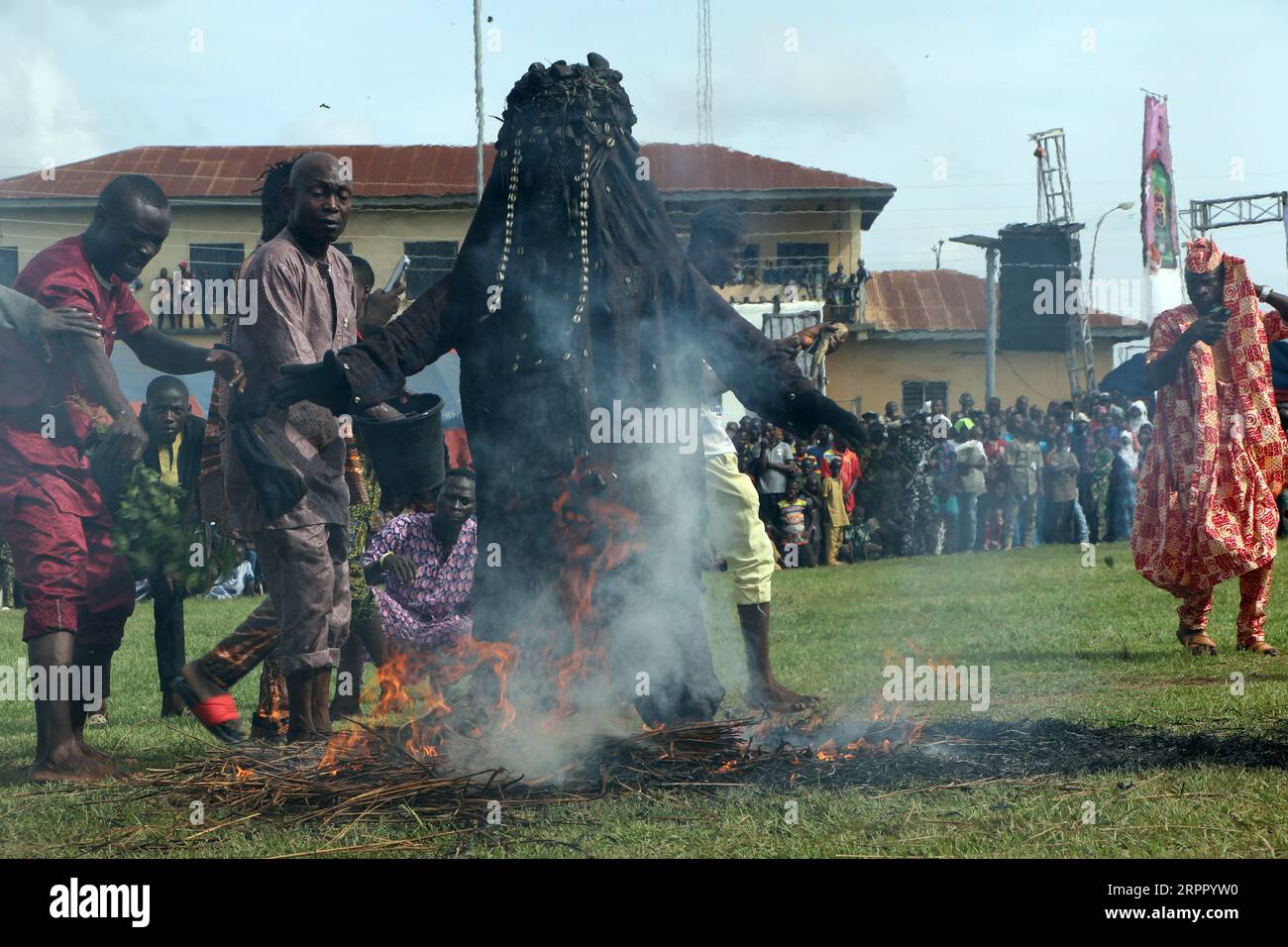 Danafojura the oldest masquerade in Oyo Kingdom, performs inside a burning fire at the World Sango Festival which is an annual festival held among the Yoruba people in honor of Sango, a thunder and fire deity who was a warrior and the third king of the Oyo Empire after succeeding Ajaka his elder brother. The festival plays host to visitors from all over the country and followers from foreign countries. Oyo state, Lagos, Nigeria. Stock Photo