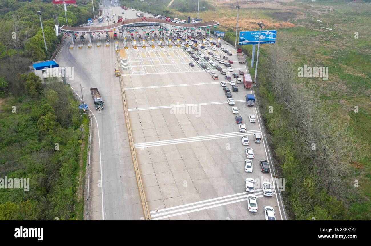 200324 -- WUHAN, March 24, 2020 -- Aerial photo taken on March 24, 2020 shows vehicles back to Wuhan wait to pass through a highway toll station in Wuhan, central China s Hubei Province. Wuhan, the Chinese city hardest hit by the novel coronavirus outbreak, will lift outbound travel restrictions from April 8 after over two months of lockdown, local authorities said Tuesday. People in Wuhan will be allowed to leave the city and Hubei Province, where Wuhan is the capital, if they hold a green health code, meaning no contact with any infected or suspected COVID-19 cases, according to a circular i Stock Photo