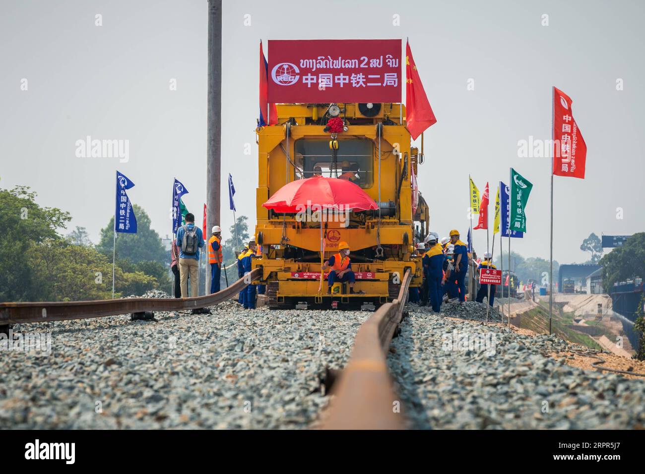 200327 VIENTIANE, March 27, 2020 Workers lay tracks at the