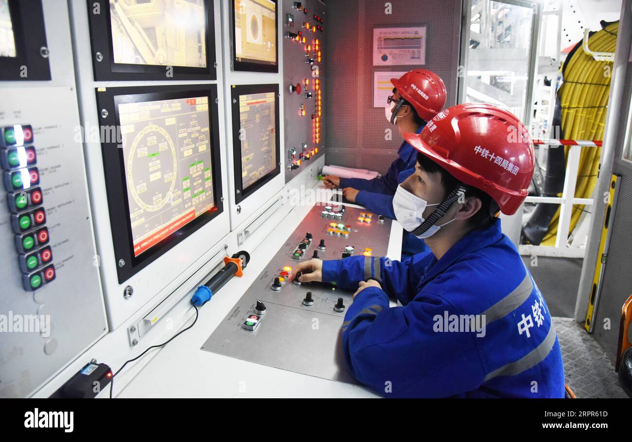 200327 -- JINAN, March 27, 2020 -- Staff members work at the construction site of the Yellow River tunnel in Jinan, capital of east China s Shandong Province, March 27, 2020. China s first Yellow River tunnel has recently resumed its all constructions, according to the China Railway Construction Corporation Limited. Located in eastern China s Jinan, the tunnel is the country s and even the world s widest shield tunnel under construction for both rail and road transport. With a total length of 4.76 km, the tunnel contains two levels. A two-way six-lane highway is on the upper level and the lowe Stock Photo