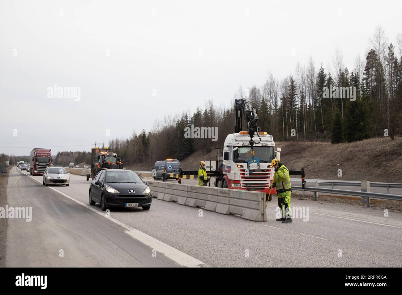 200328 -- HELSINKI, March 28, 2020 Xinhua -- Road workers and local police set up checkpoints on a road in Hyvinkaa, on the northern edge of the Uusimaa region in Finland, March 27, 2020. To prevent the further spread of the coronavirus, the Finnish government on Wednesday launched a plan to block the country s hardest-hit Uusimaa region, which includes the capital Helsinki. The lockdown was expected to start on Friday night under police supervision. Photo by Matti Matikainen/Xinhua FINLAND-HYVINKAA-LOCKDOWN PUBLICATIONxNOTxINxCHN Stock Photo