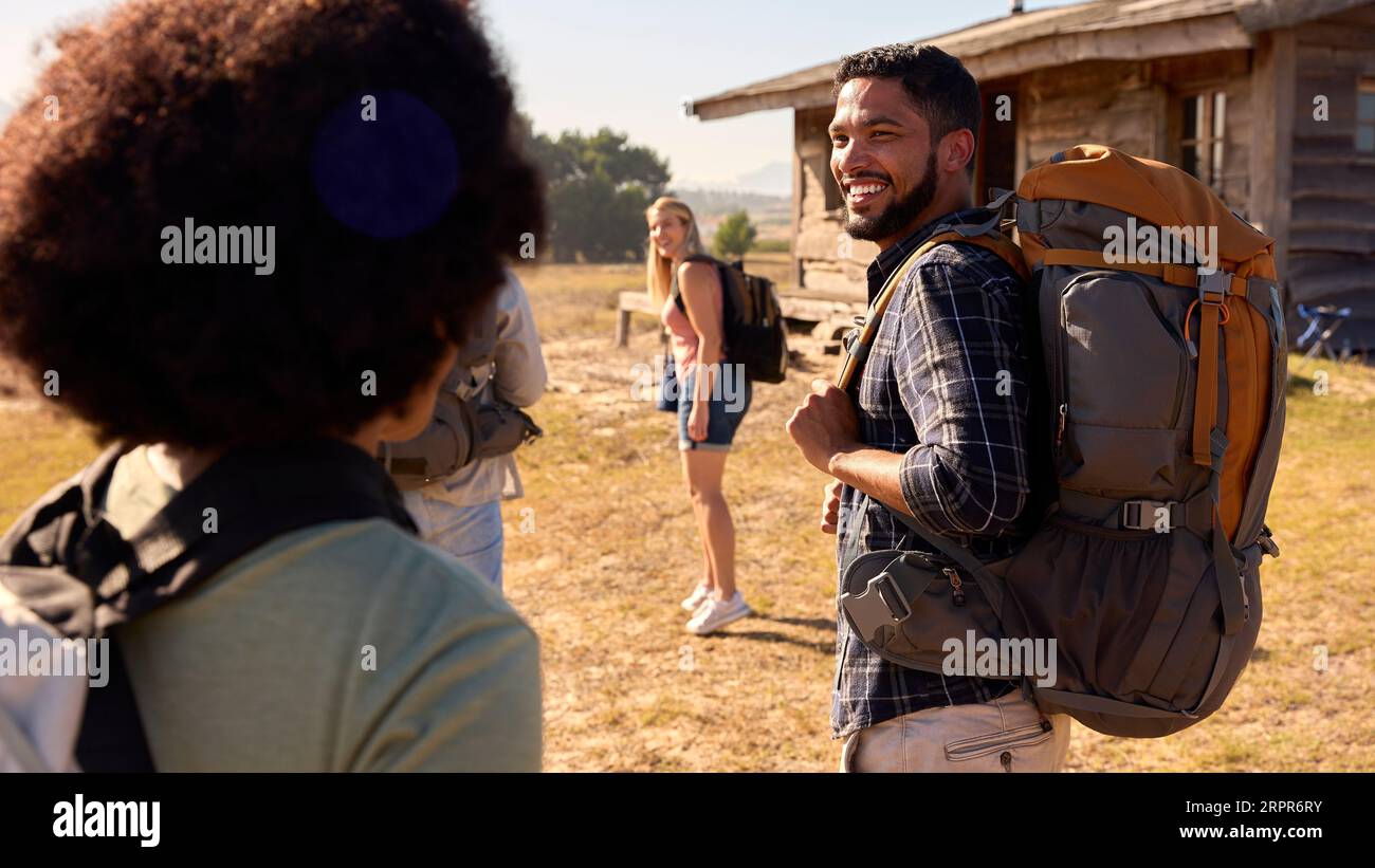 Group Of Friends With Backpacks Hiking In Countryside Together Stock ...