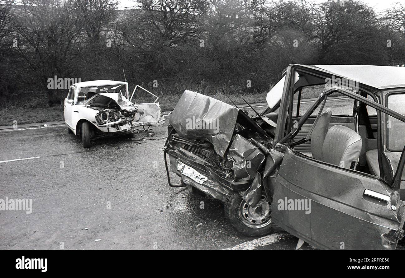 1983, historical, crashed cars lying sideways on a wet A road, after a head on smash, Yorkshire, England, UK. Stock Photo