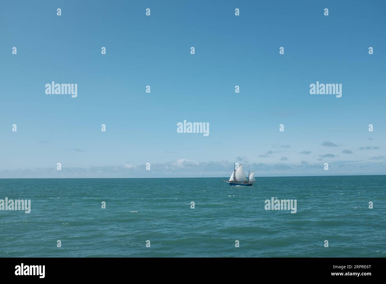 An aerial view of a majestic white sailboat sailing across the ocean's ...