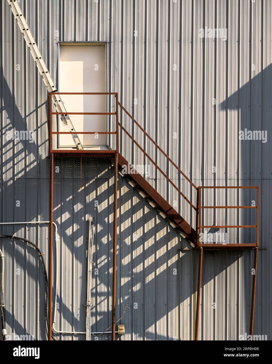 Shadows from fire escape stairs Stock Photo