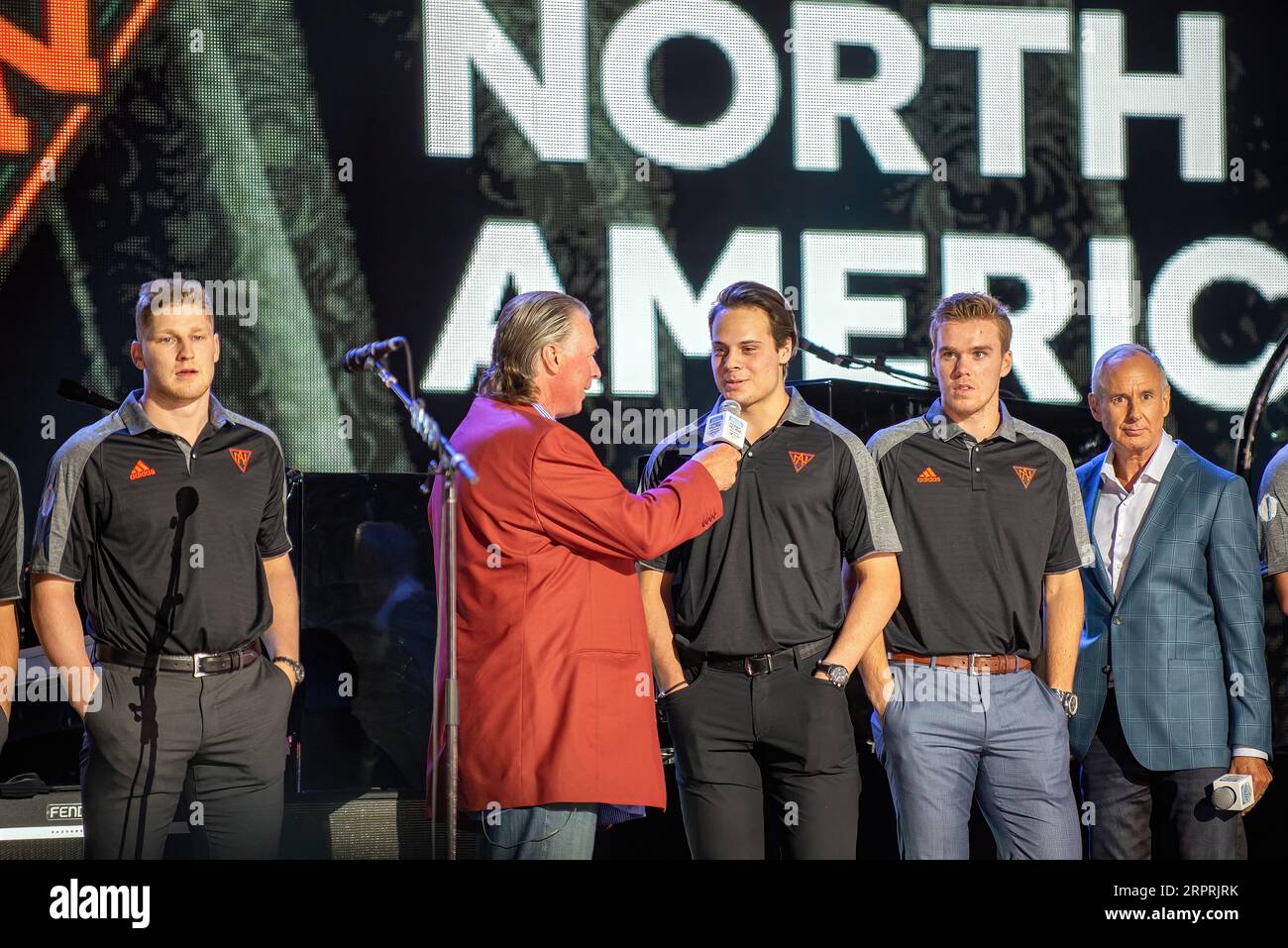 Toronto, Canada – September 16, 2016:  Barry Melrose interviews Auston Matthews as Nathan MacKinnon, L, and Connor McDavid of Team North America, the under 23 team at the World Cup of Hockey premiere party, stand by. Ron MacLean is seen on the right. Stock Photo