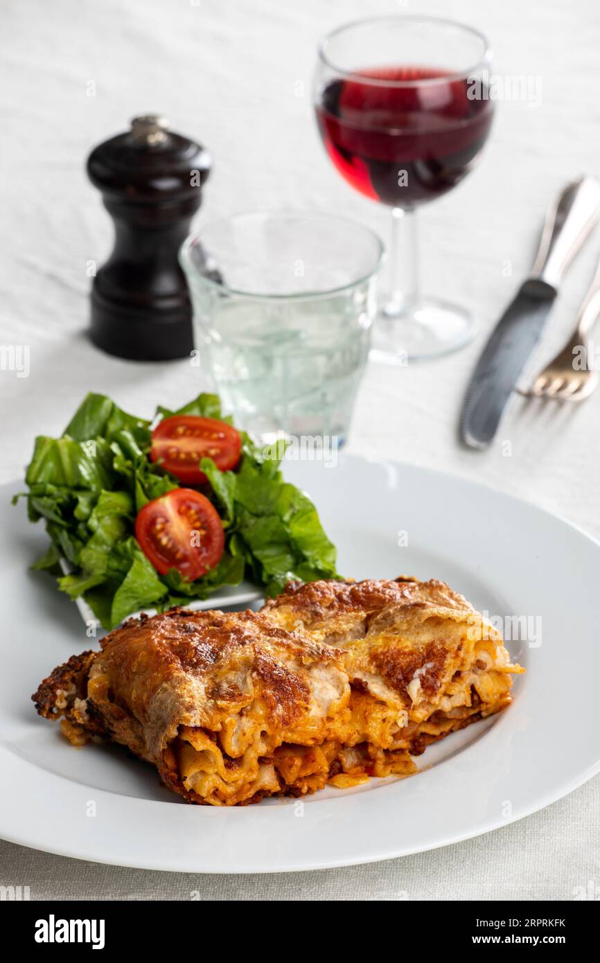 portion of lasagna on a white plate Stock Photo