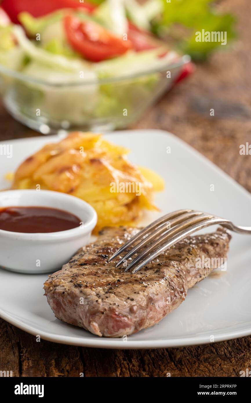 steak on a plate with potato gratin Stock Photo