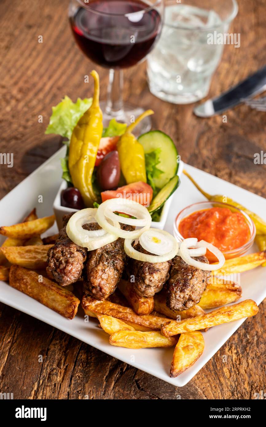 cevapcici with french fries and onion rings Stock Photo