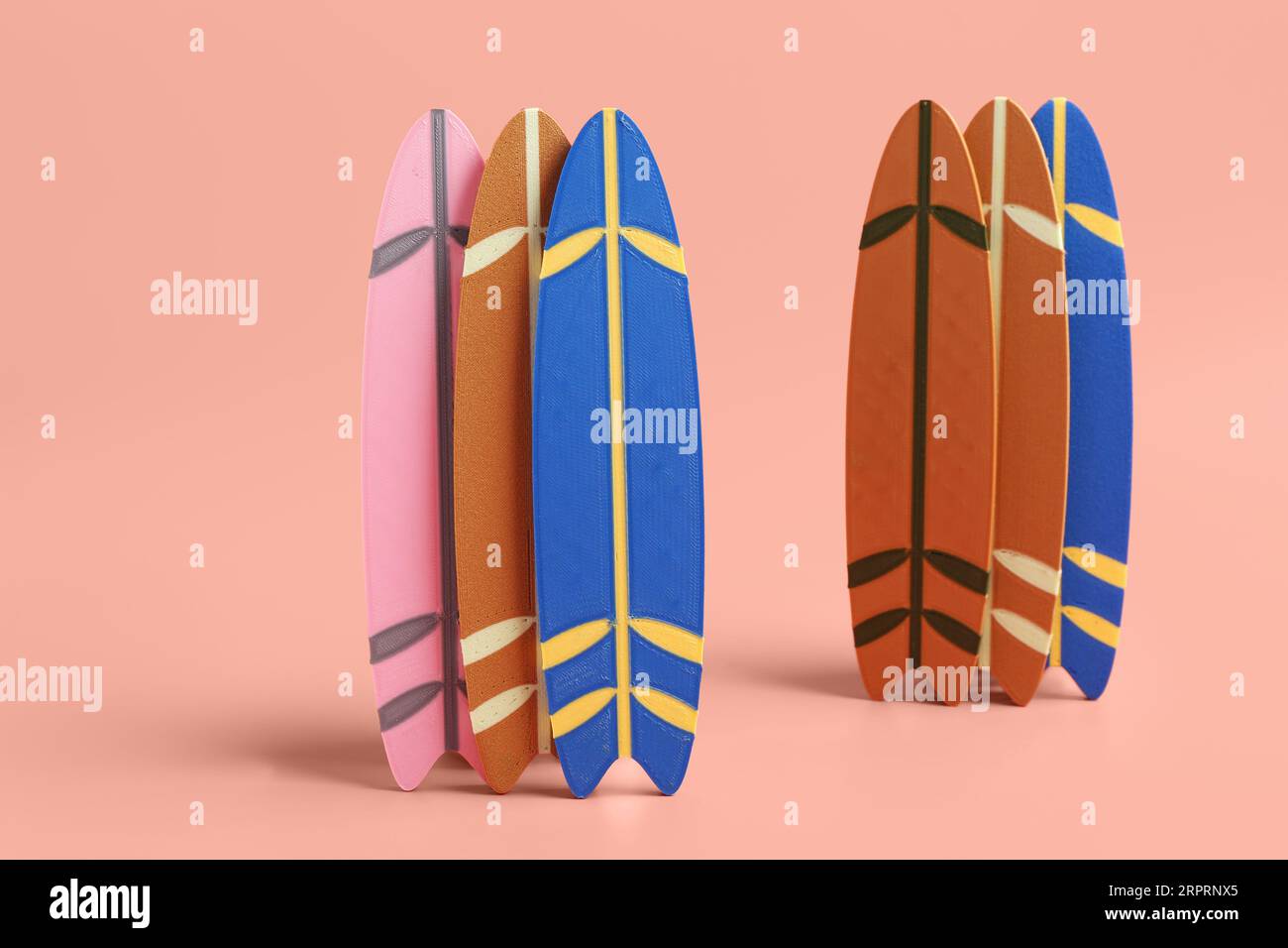 Different mini surfboards on pink background Stock Photo Alamy