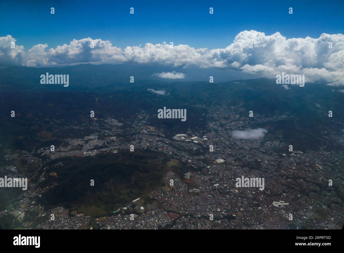 Aerial view of the land from the airplane with clouds Stock Photo