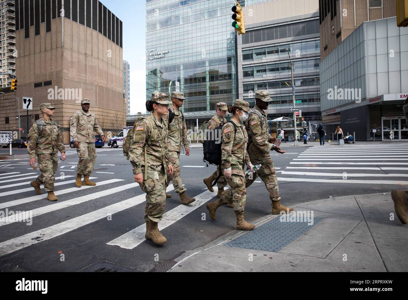 200409 -- NEW YORK, April 9, 2020 Xinhua -- Soldiers cross a street in front of NYU Langone Medical Center during the coronavirus pandemic in New York, the United States, April 8, 2020. The number of COVID-19 cases in the United States reached 401,166 as of 12:20 local time on Wednesday 1620 GMT, according to the Center for Systems Science and Engineering CSSE at Johns Hopkins University. A total of 12,936 deaths were reported in the nation, according to the CSSE. Photo by Michael Nagle/Xinhua U.S.-NEW YORK-COVID-19 PUBLICATIONxNOTxINxCHN Stock Photo