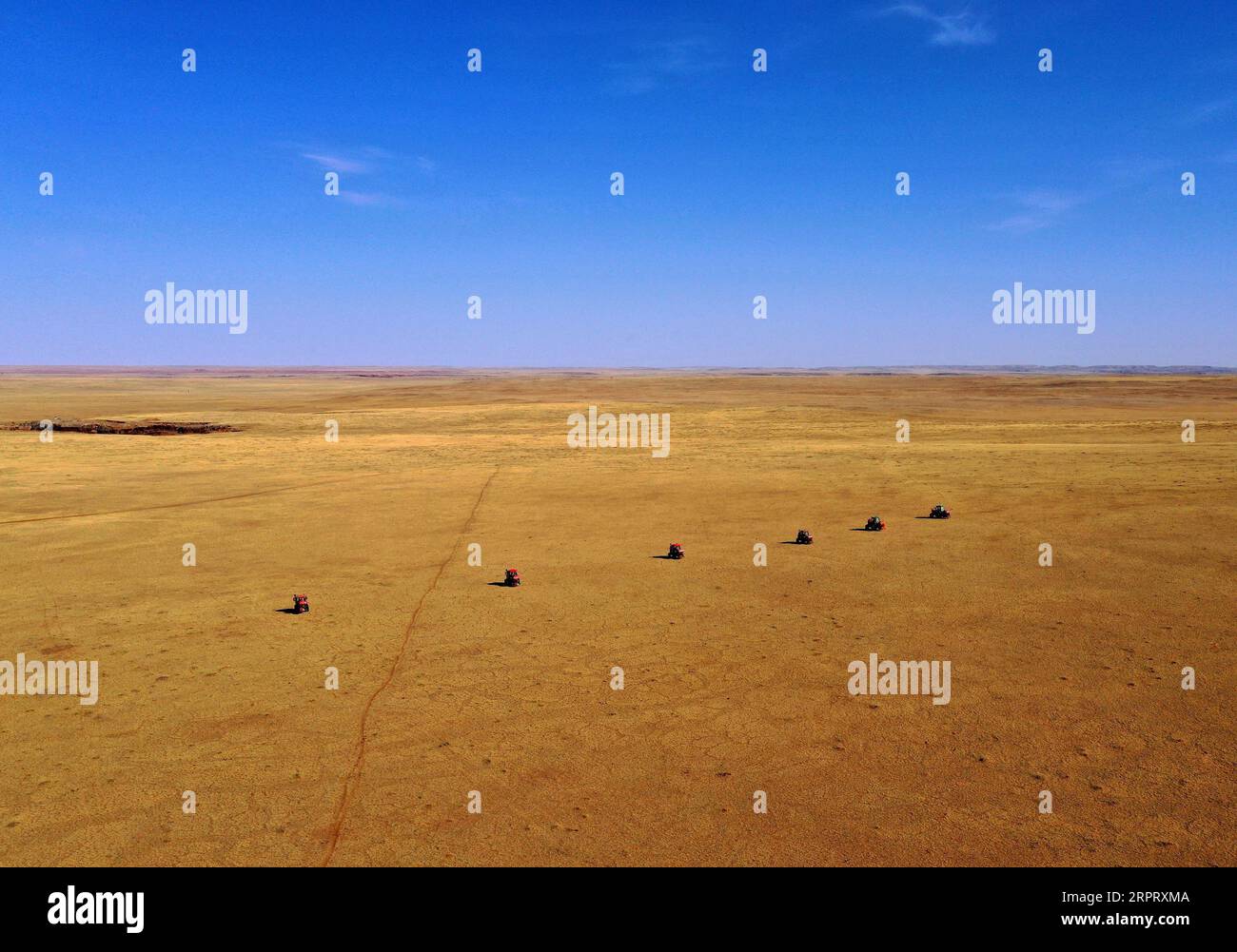 200409 -- BEIJING, April 9, 2020 -- Aerial photo taken on April 7, 2020 shows tractors spraying rodenticide bait on the grassland in Sonid Right Banner, north China s Inner Mongolia Autonomous Region.  XINHUA PHOTOS OF THE DAY RenxJunchuan PUBLICATIONxNOTxINxCHN Stock Photo