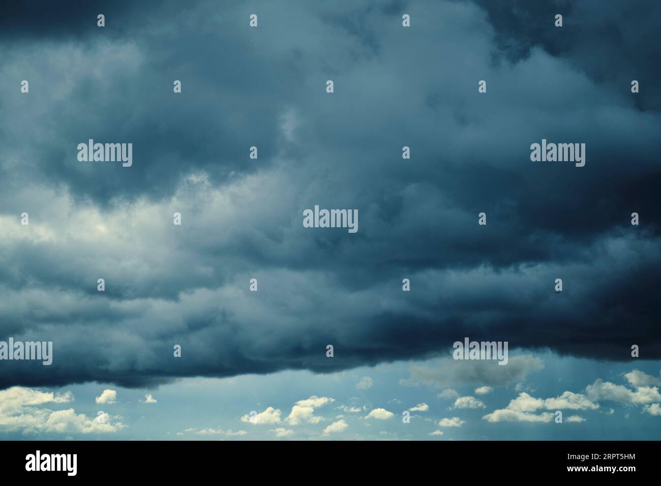 Dark storm clouds with breaking sunlight Stock Photo