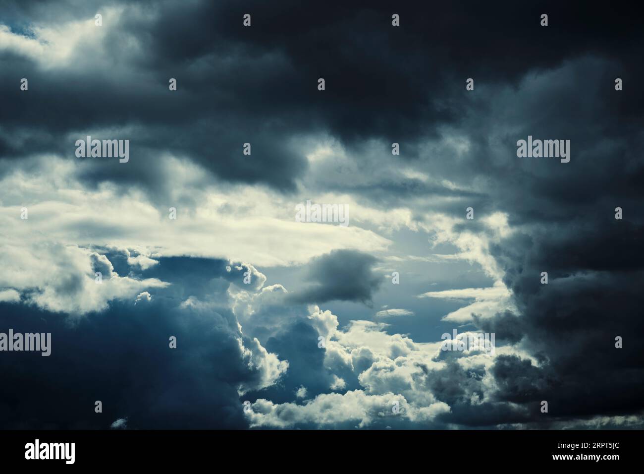 Dark storm clouds with breaking sunlight Stock Photo