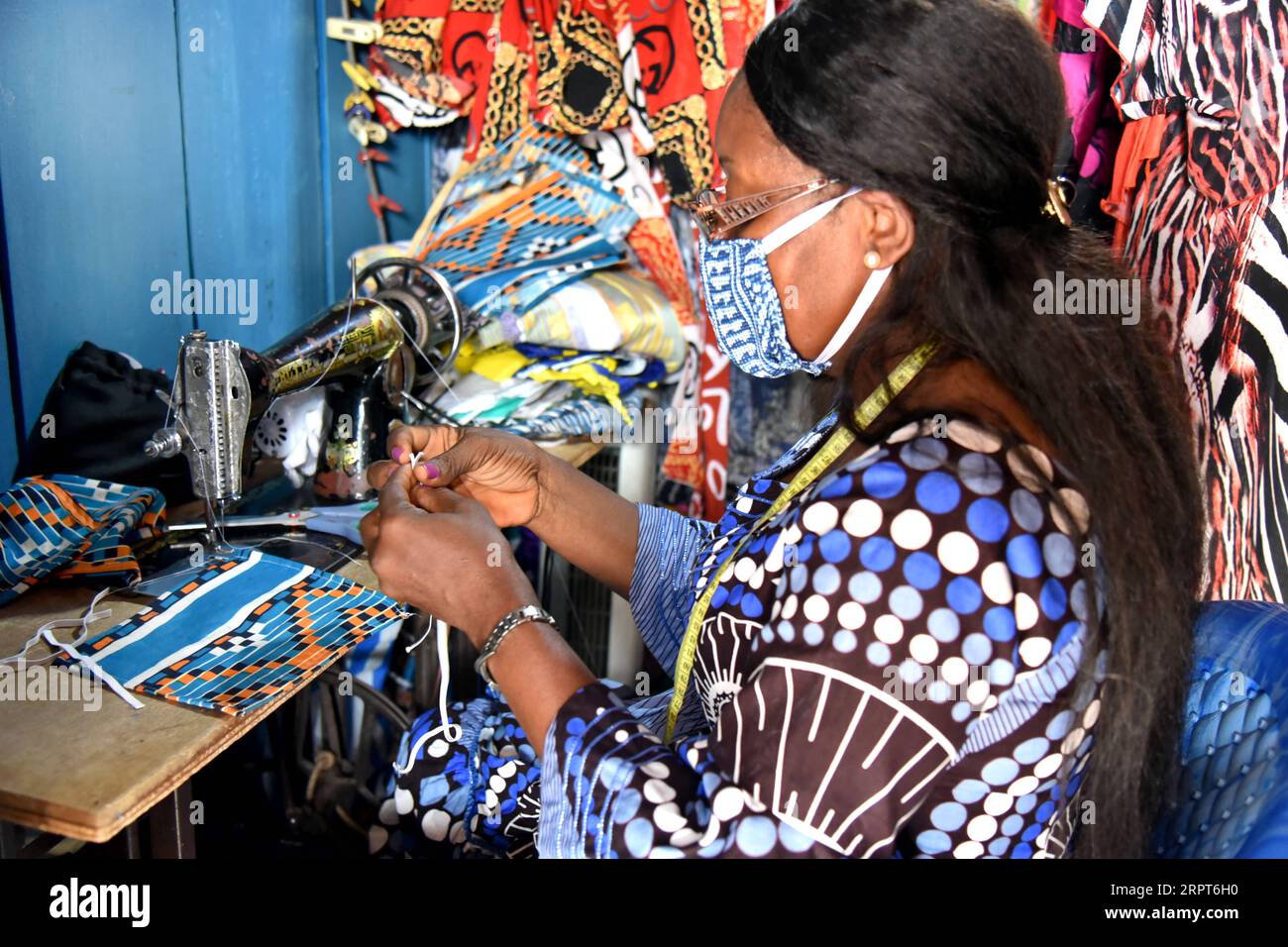 200412 -- YAOUNDE, April 12, 2020 Xinhua -- Angeline Toungsi, a Cameroonian tailor, sews cloth face masks at her workshop in Yaounde, Cameroon on April 9, 2020. Recently, the wearing of a protective mask has become mandatory for all Cameroonians wishing to approach certain hospitals and public services, like the General Hospital of Yaounde, and government bodies in the country s southwest region. Photo by Jean Pierre Kepseu/Xinhua CAMEROON-YAOUNDE-COVID-19-FACE MASKS PUBLICATIONxNOTxINxCHN Stock Photo