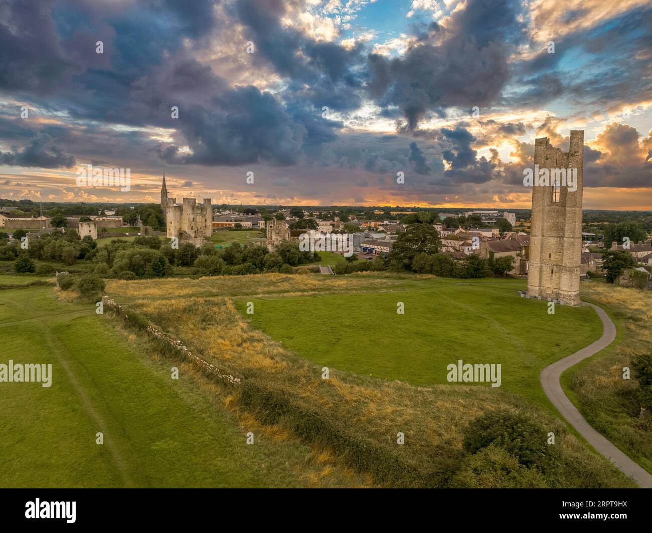 Aerial view of Trim castle, town and St Mary's Abbey ruined Gothic church tower with dramatic