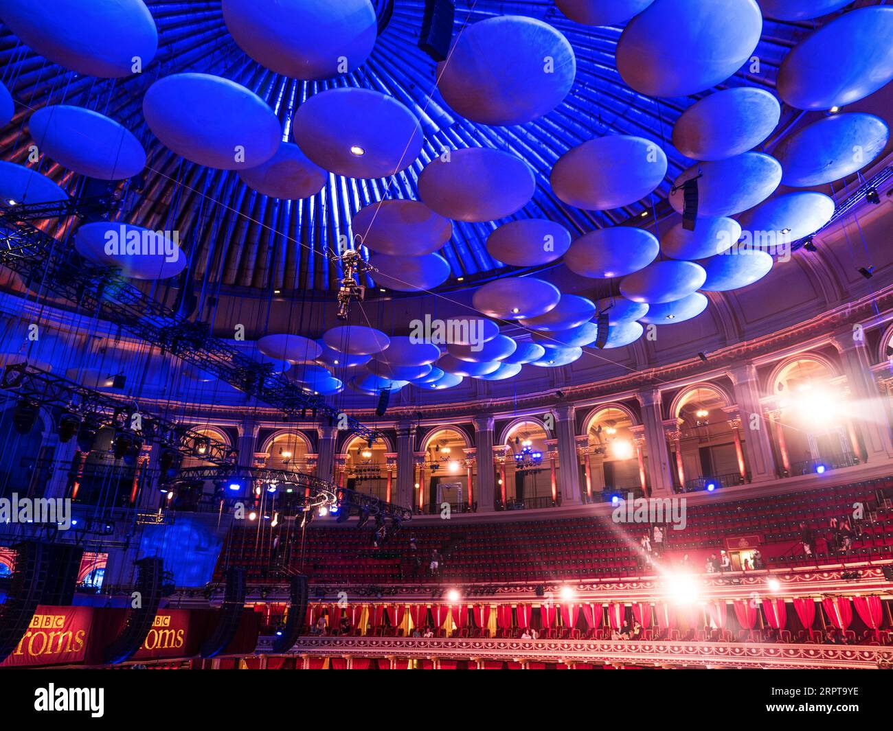 ALBERT HALL ACOUSTIC SOUND CORRECTION REFLECTORS in dome of Albert Hall with TV lighting flare flaring and 'Proms Signs' Albert Hall Kensington London UK. Promenade Concerts Auditorium Interior Stock Photo