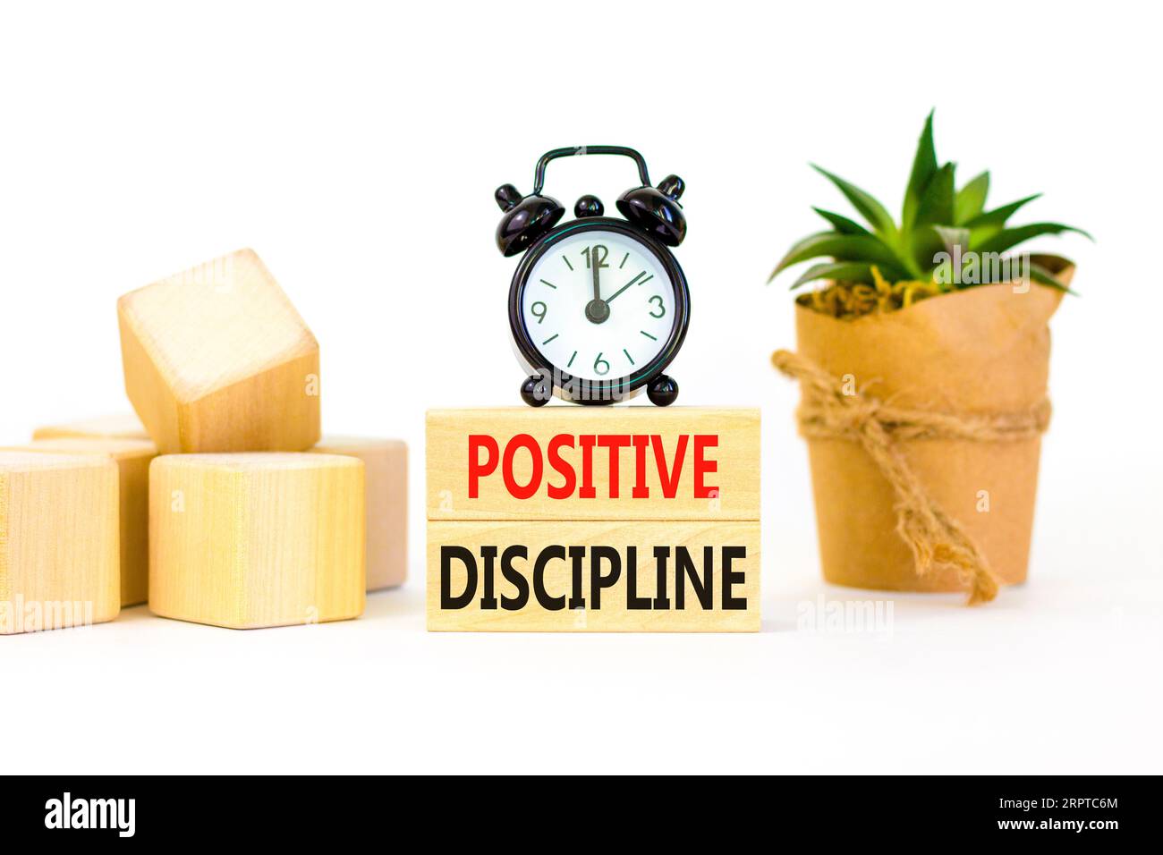 Positive discipline symbol. Concept words Positive discipline on beautiful wooden blocks. Beautiful white background. Black alarm clock. Business psyc Stock Photo