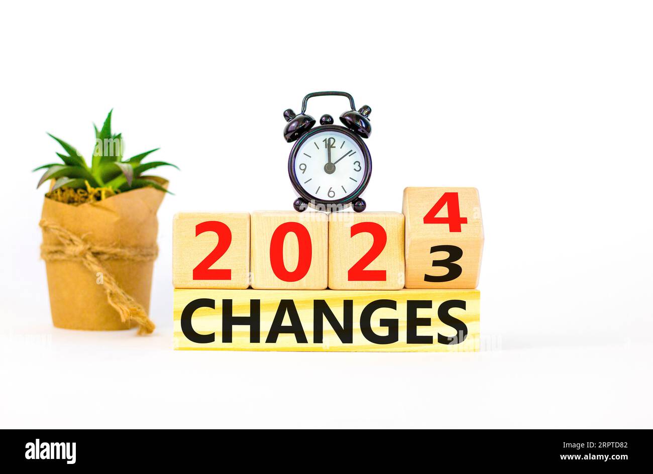 Planning 2024 changes new year symbol. Businessman turns a wooden cube