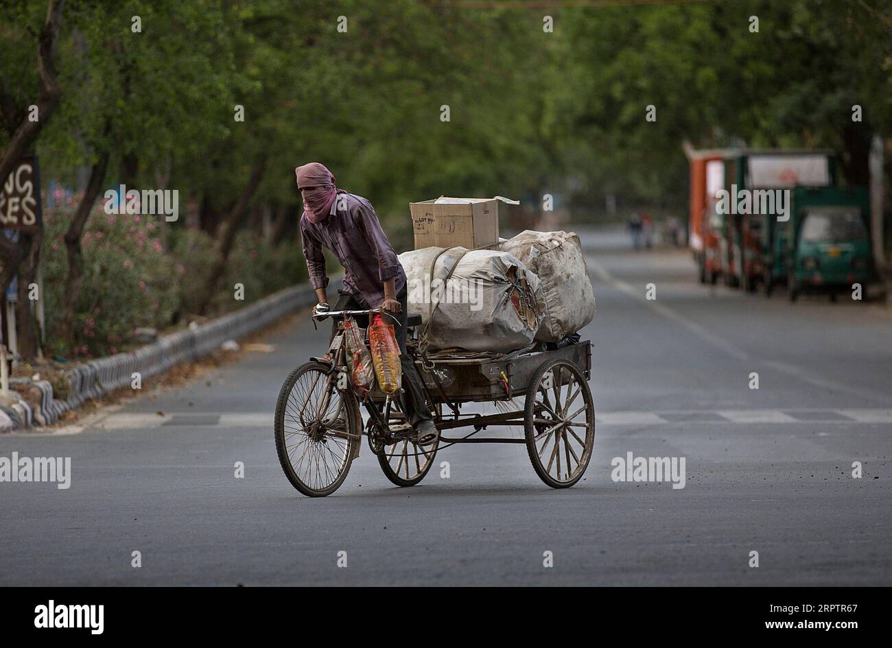 200417 -- NEW DELHI, April 17, 2020 -- A ragpicker drives his rickshaw on an empty road during the lockdown due to COVID-19, in New Delhi, India, April 17, 2020. India s federal health ministry Friday evening said the death toll due to COVID-19 in India rose to 452 and the total number of confirmed cases in the country reached 13,835.  INDIA-NEW DELHI-COVID-19 JavedxDar PUBLICATIONxNOTxINxCHN Stock Photo