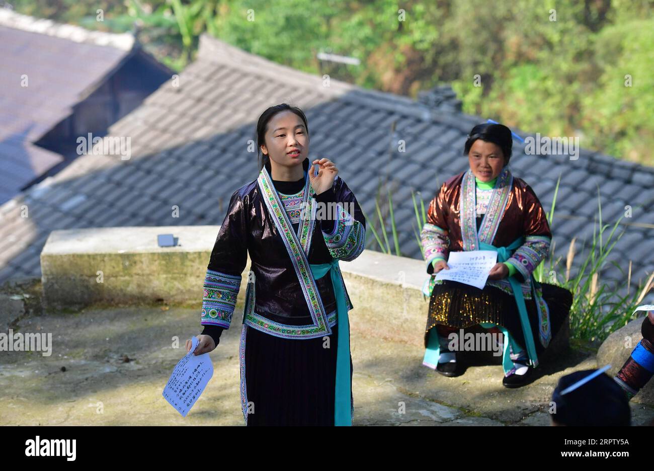 200419 -- RONGSHUI, April 19, 2020 -- Liang Mengxiang teaches Mandarin to local women during a Mandarin training class held in Wuying, a village of Miao ethnic group on the border of south China s Guangxi Zhuang Autonomous Region and southwest China s Guizhou Province, April 16, 2020. Liang Mengxiang, 21, is a college student of Miao ethnic group born in Dangjiu Village, who studies at south China s Guangxi Science and Technology Normal University. Dangjiu is a remote, poverty-stricken village where women over 40 years old hardly ever attended any school, which was believed to be one of the ma Stock Photo